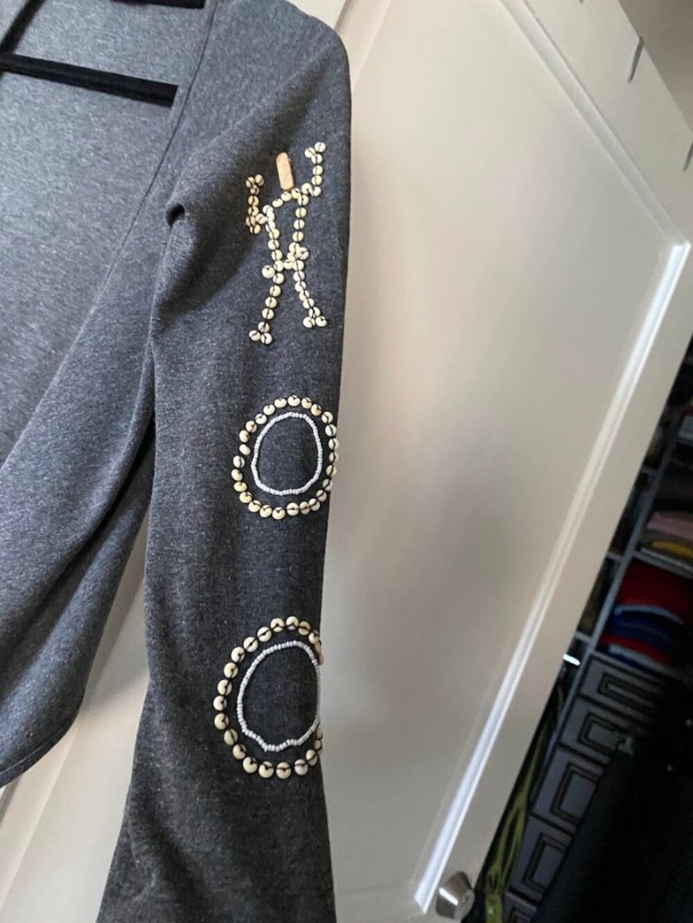 Gray Ferretti open-front cardigan with unique embellished details on the sleeve.